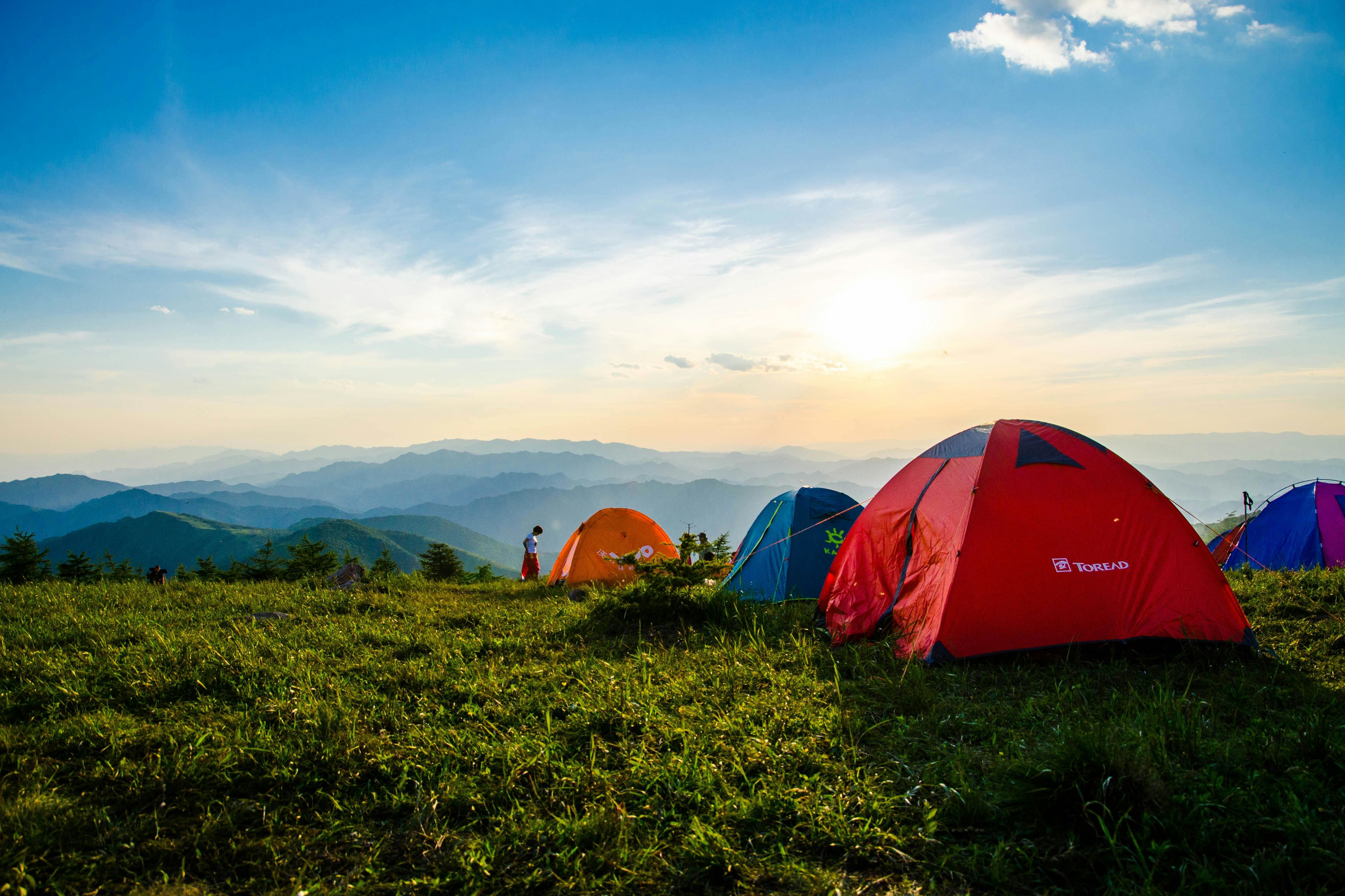 photo of pitched dome tents overlooking mountain ranges