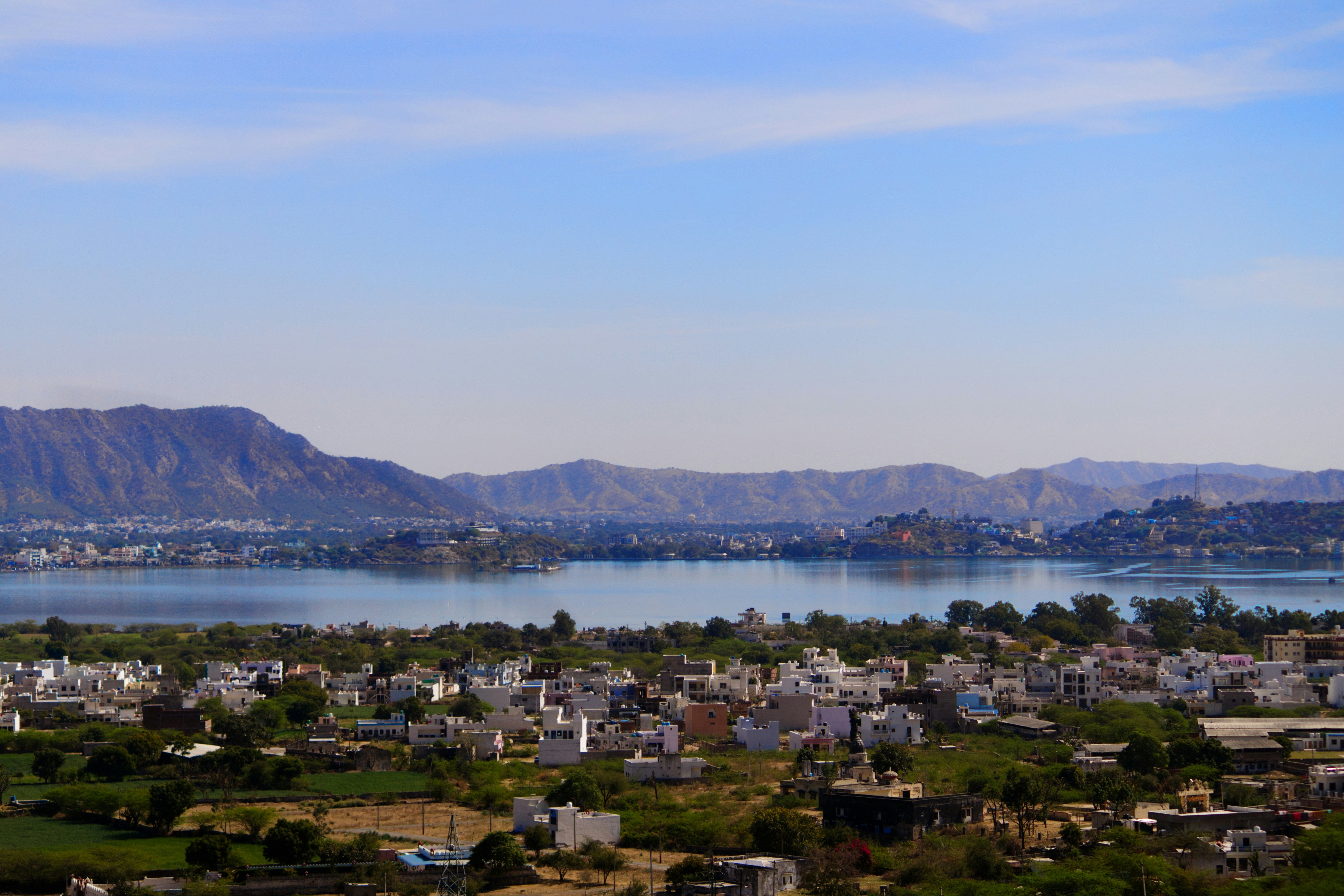 view of pushkar city near lake and mountain during daytime