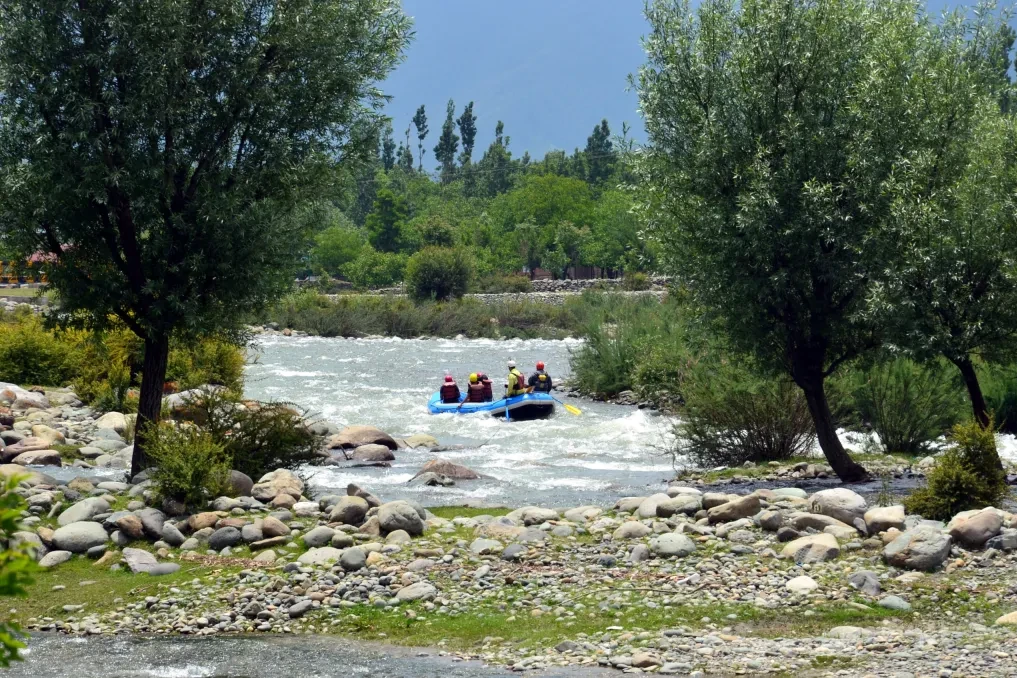 a group of tourists rafting at lidder river in pahalgam