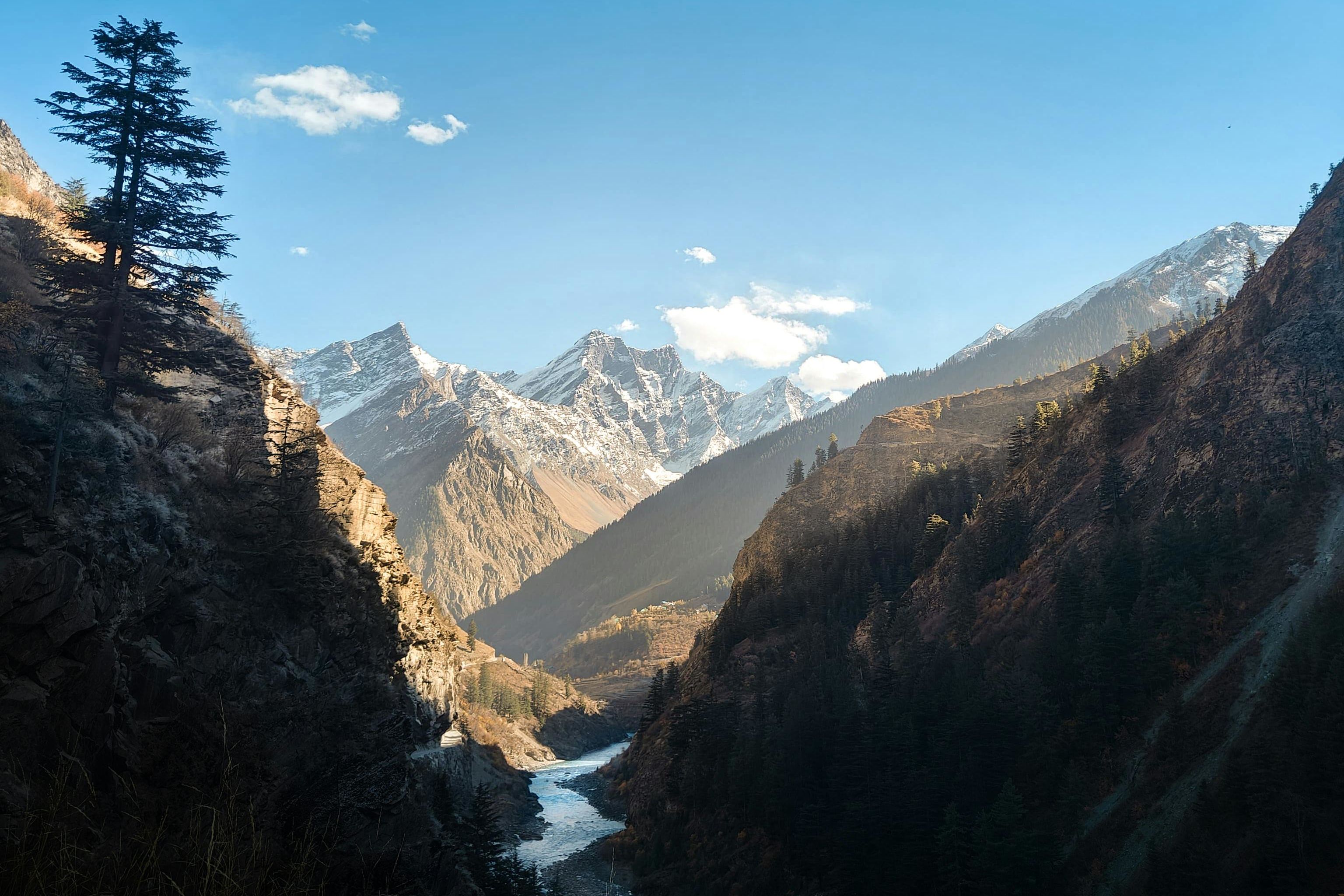 a river flowing through a valley in lahaul and spiti
