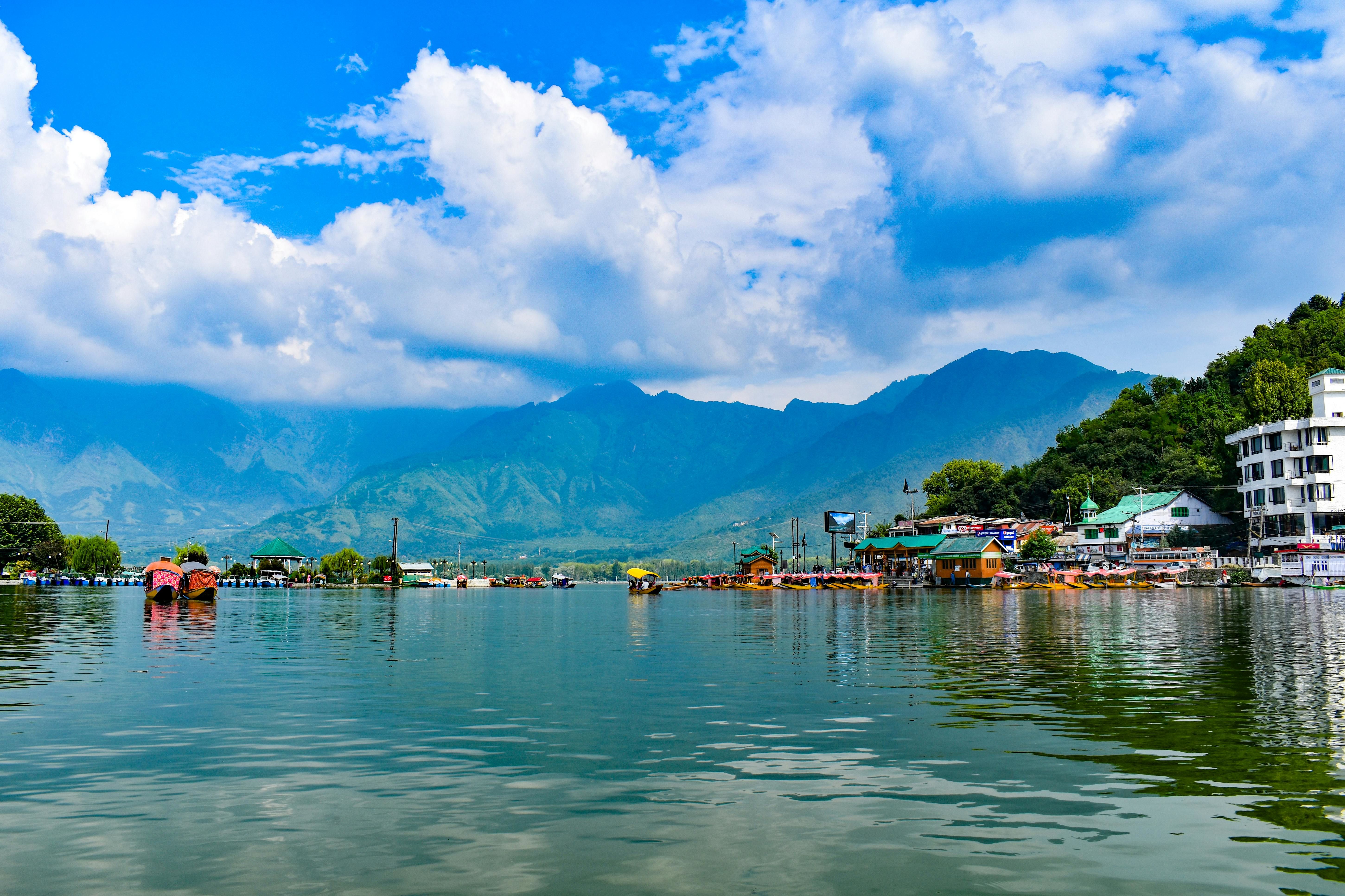 scenic view of dal lake with himalayan mountains in the backdrop