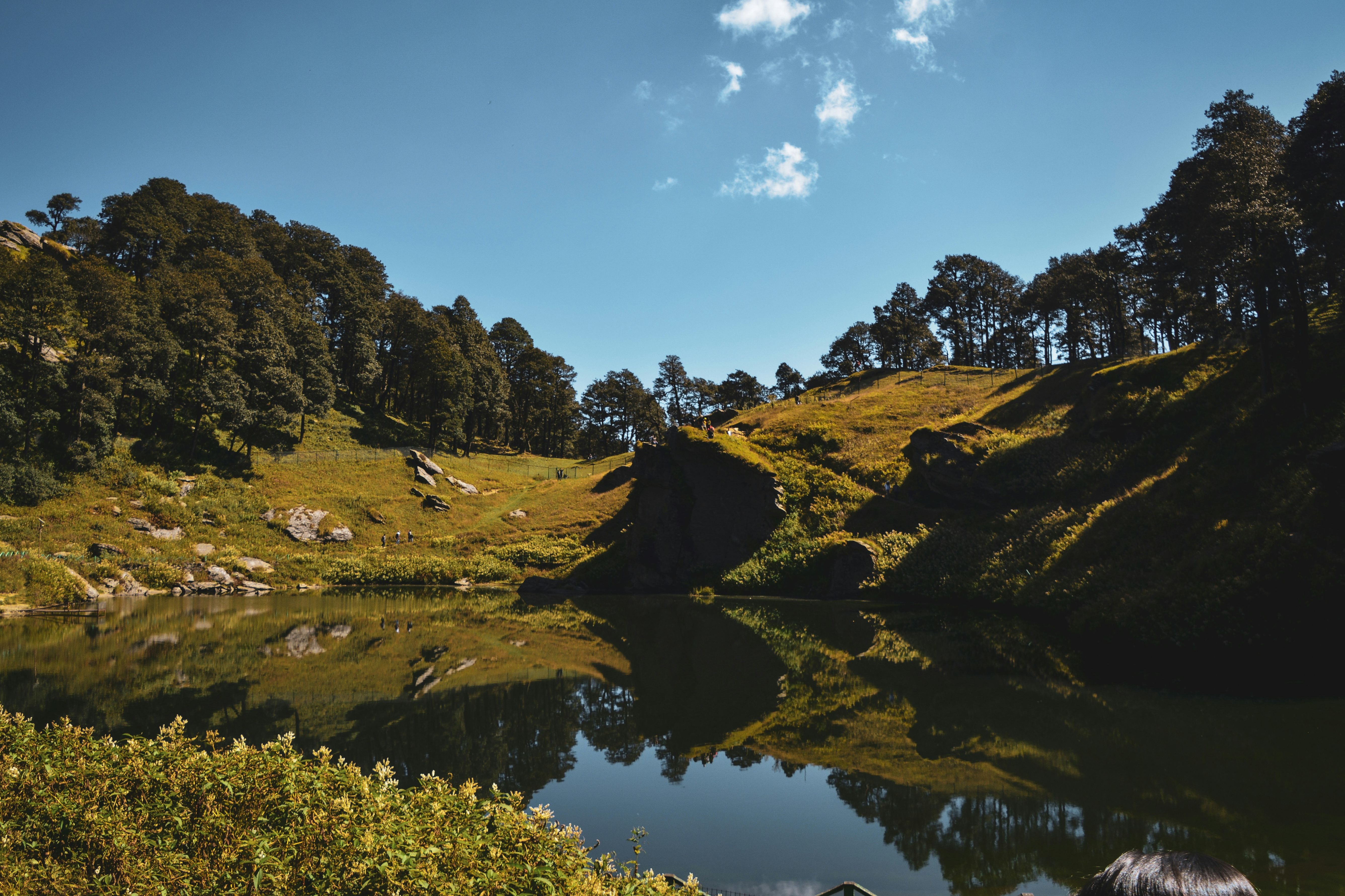 serolsar lake in jibhi surrounded by lush green hillside