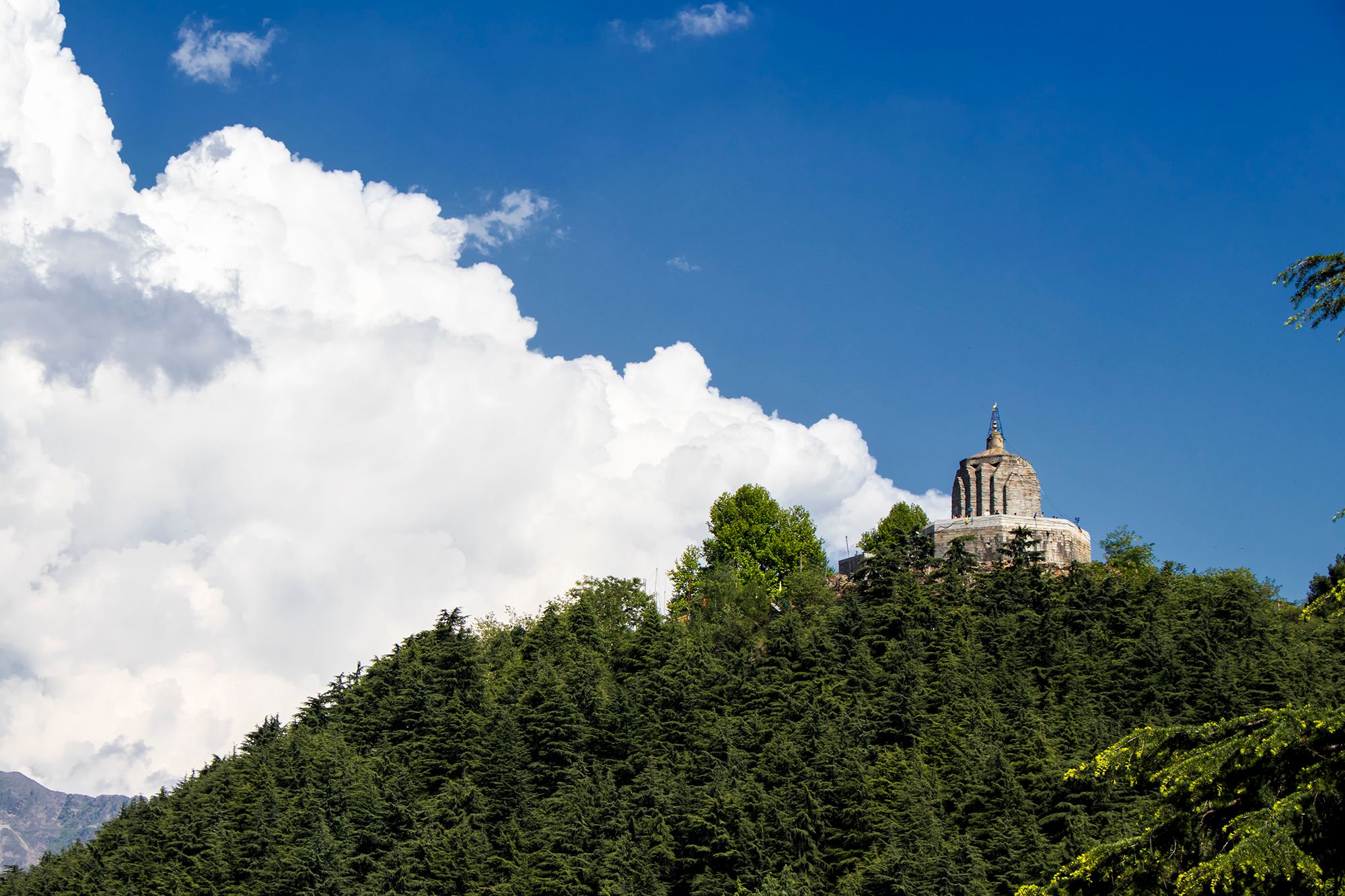 view of shankaracharya temple surrounded by trees on a mountain top in srinagar