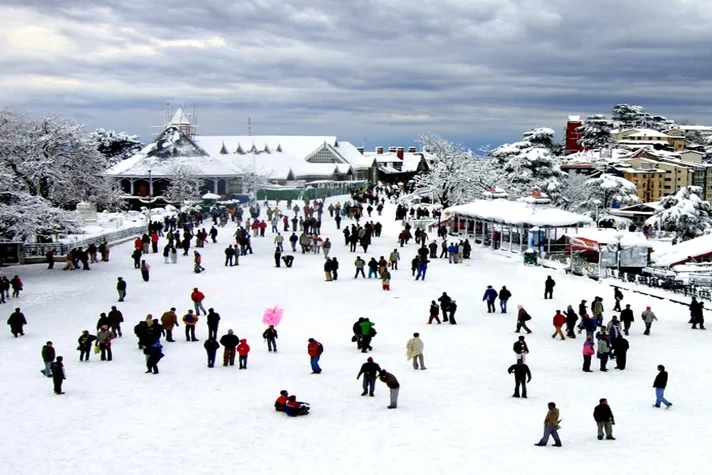 tourists walking on snow covered ridge in shimla during winter
