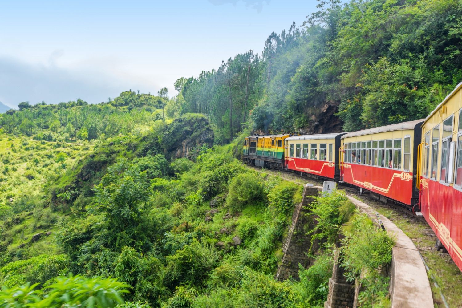 toy train passing through green mountains