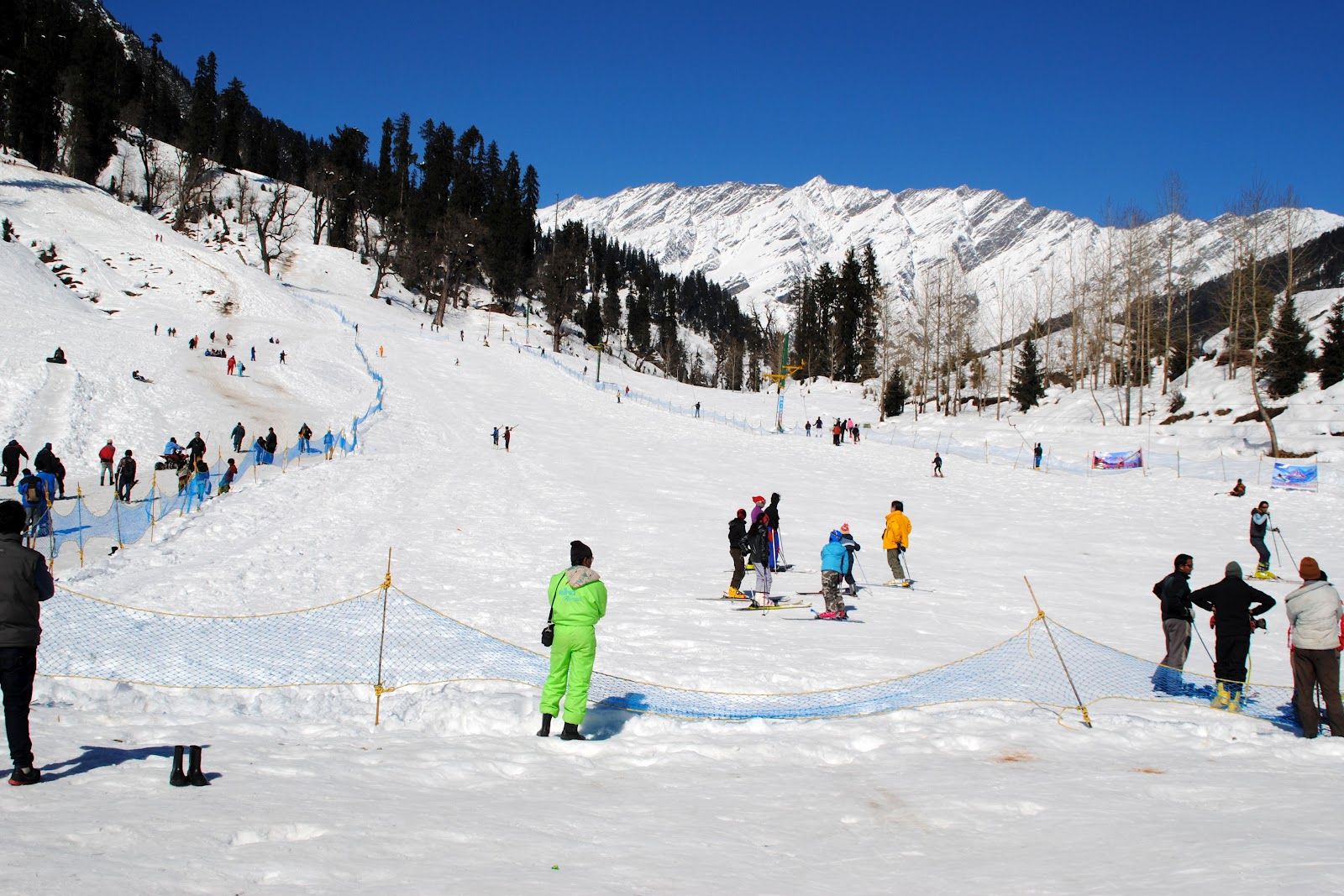 people doing snow activity near solang valley