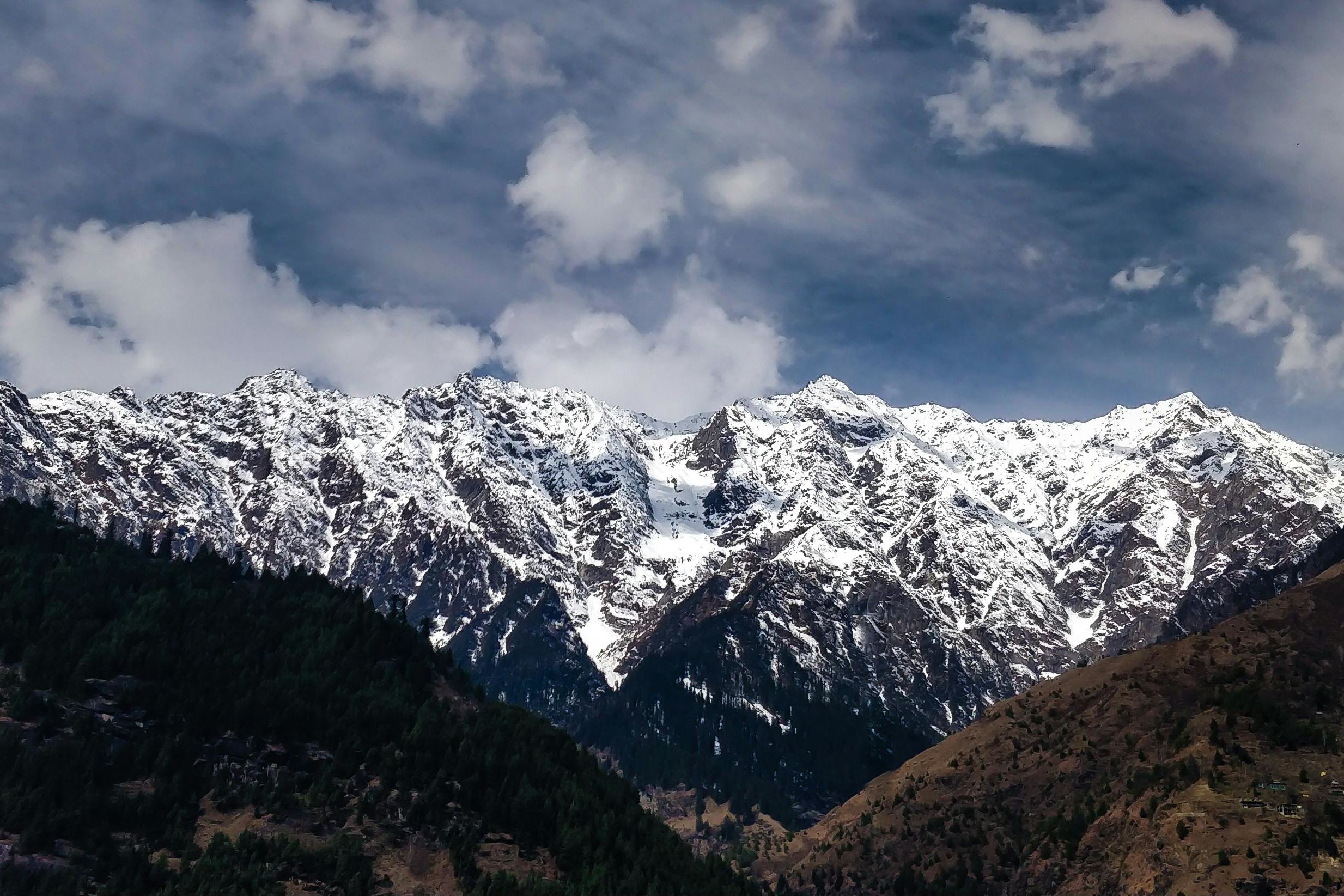 snow capped mountains under clouds and blue sky in shimla