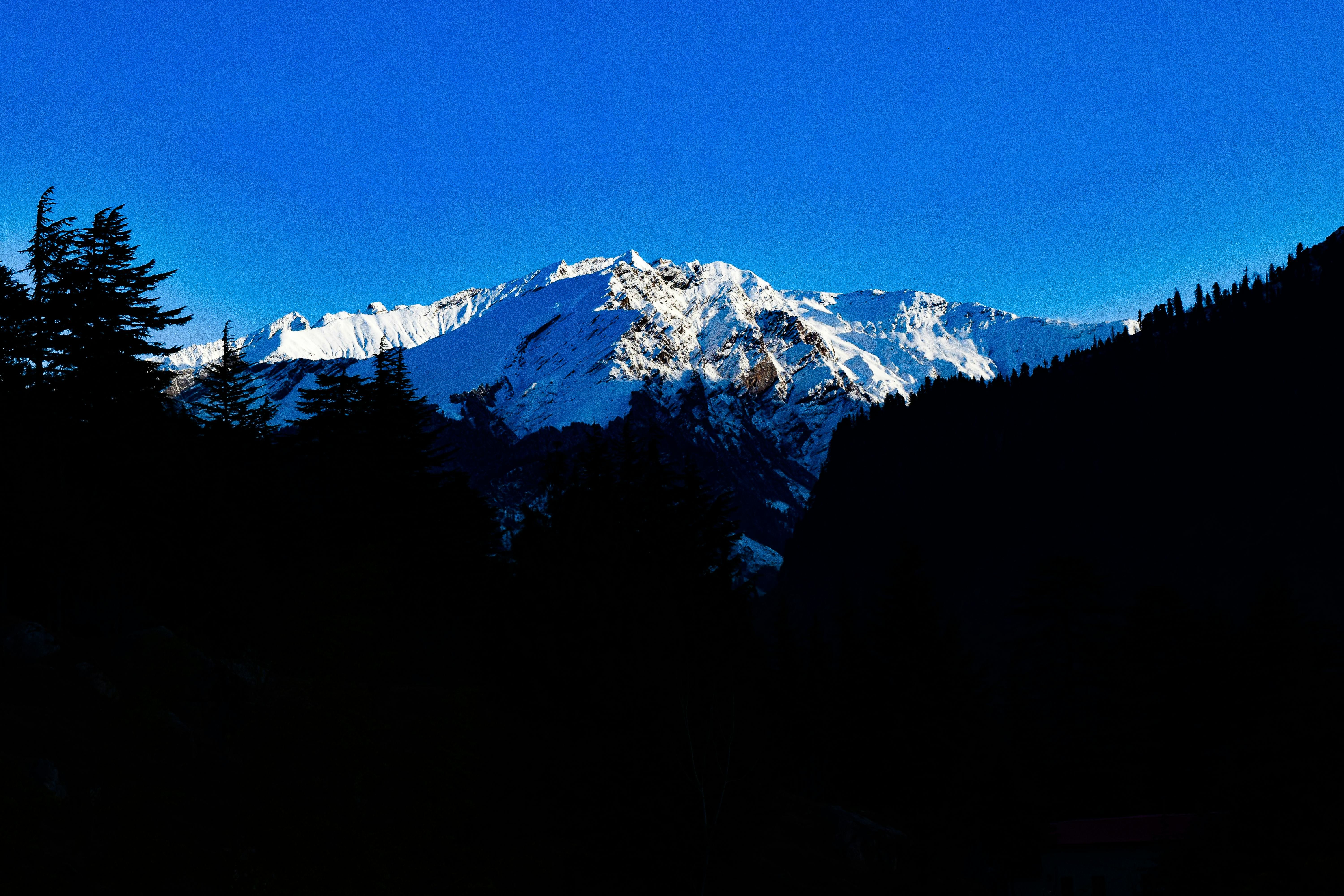 snow covered mountain peak under blue sky in manali
