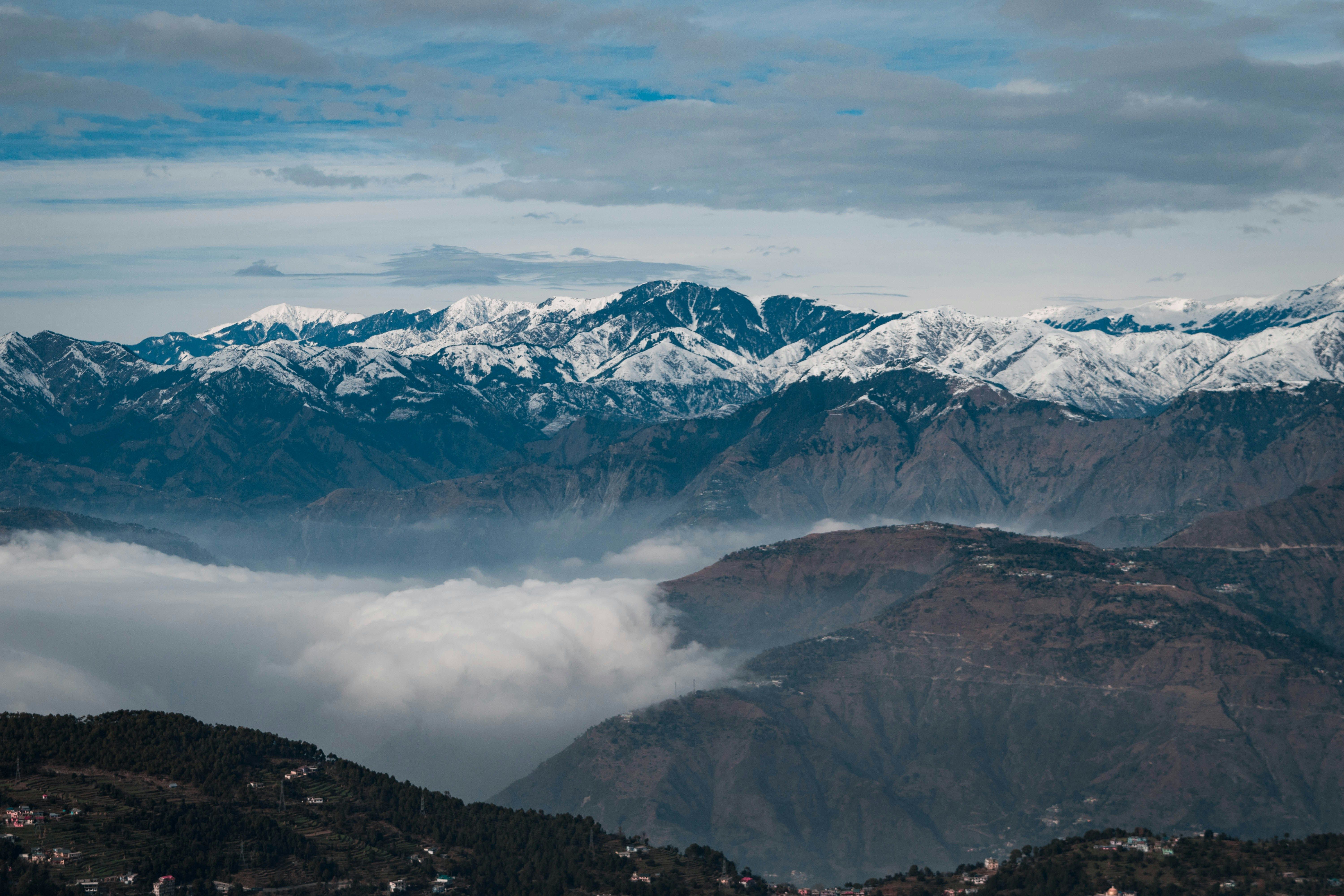 snow covered mountains in dalhousie under cloudy sky during daytime