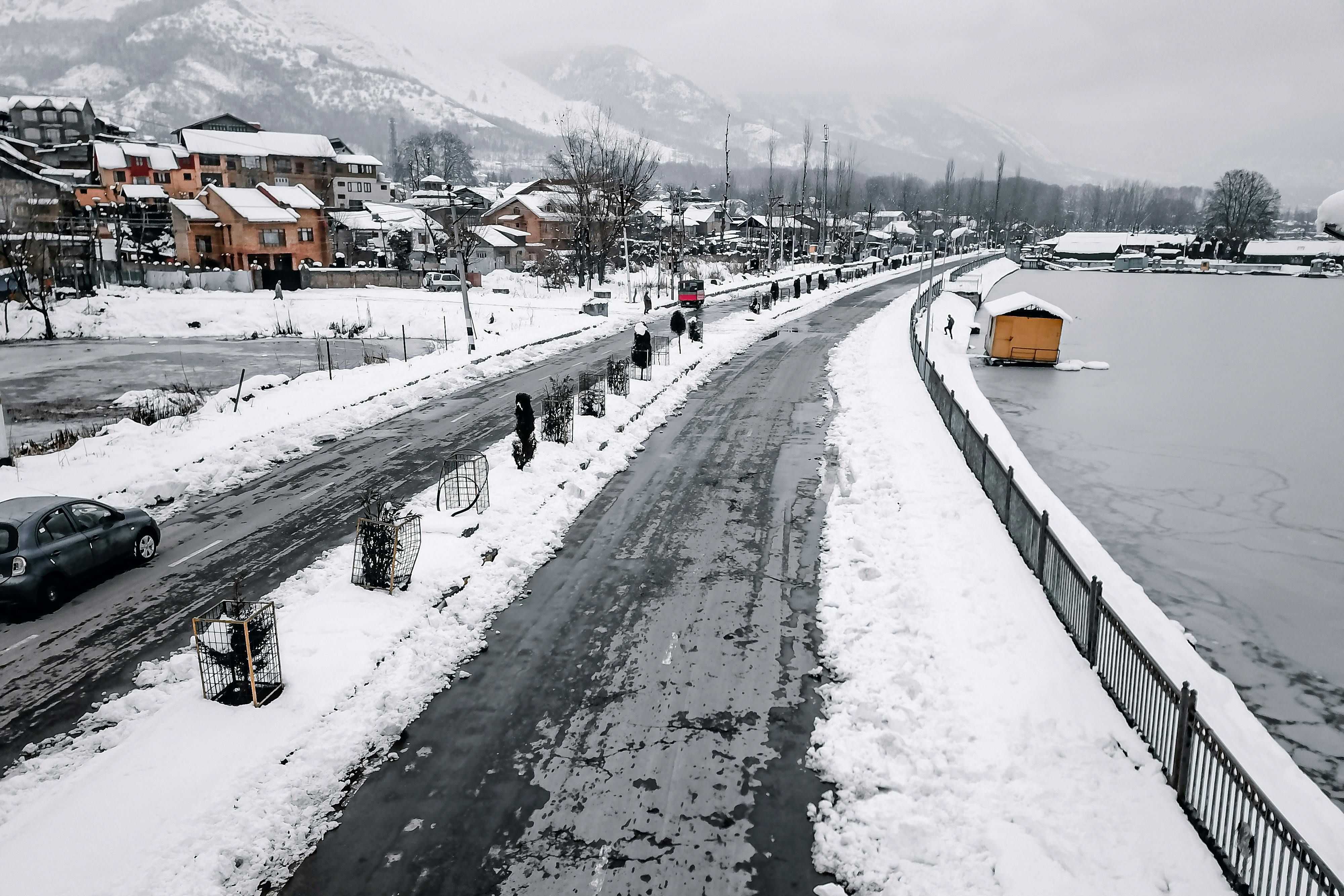 snow covered road in srinagar during winter