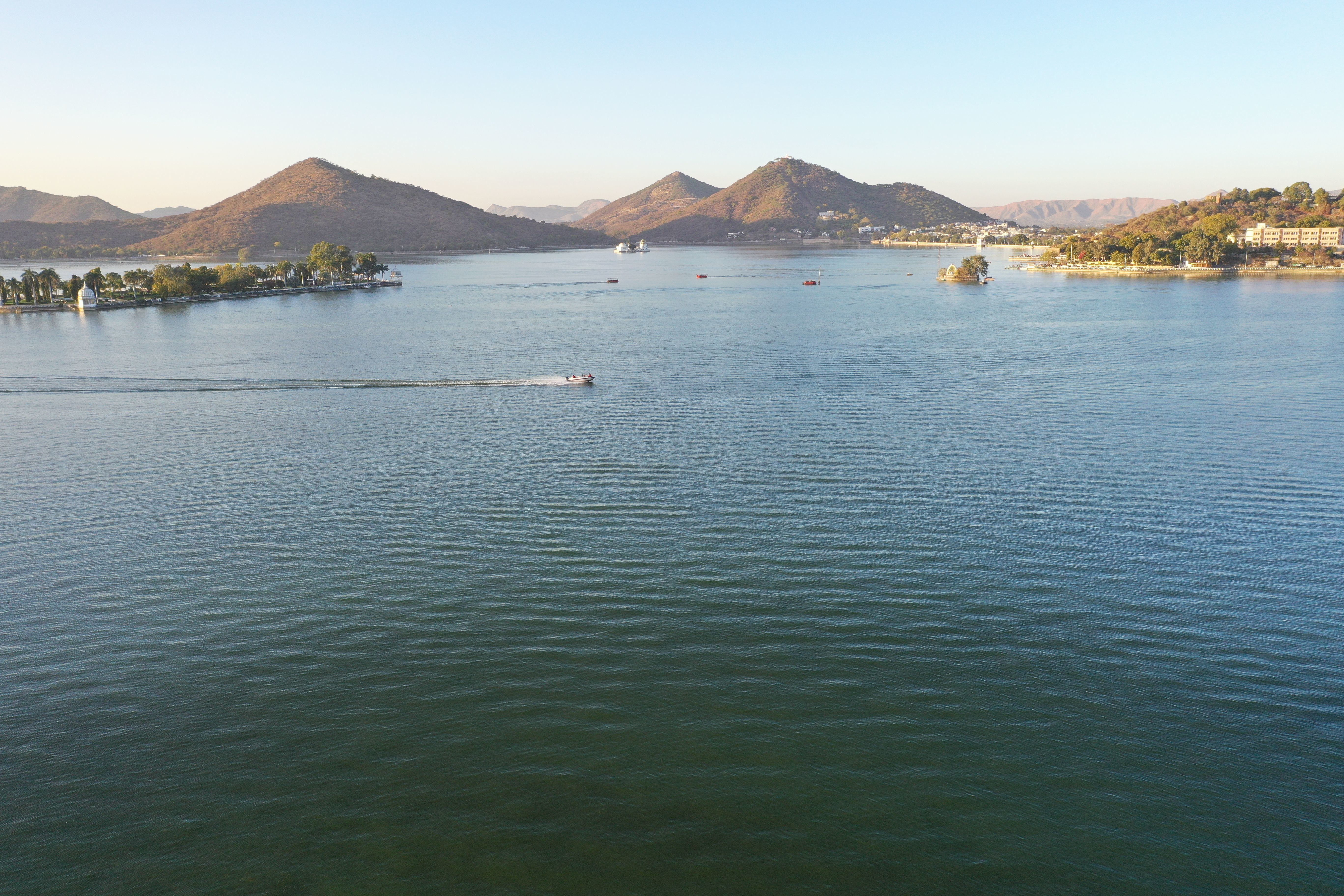 stunning aerial shot of lake pichola with mountains and tranquil water in udaipur