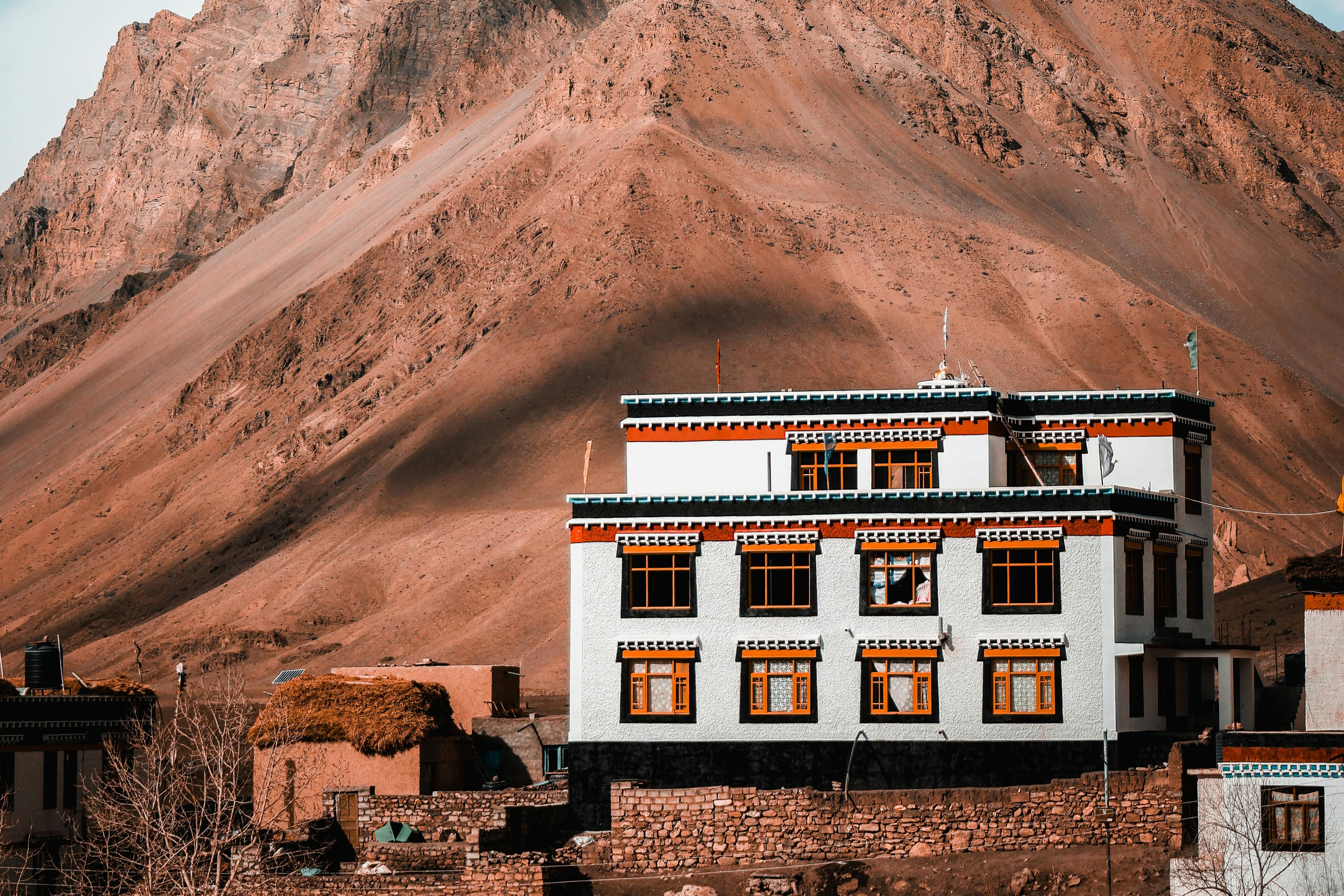 view of a stunning himalayan mountain with a monastery in front of it in spiti valley