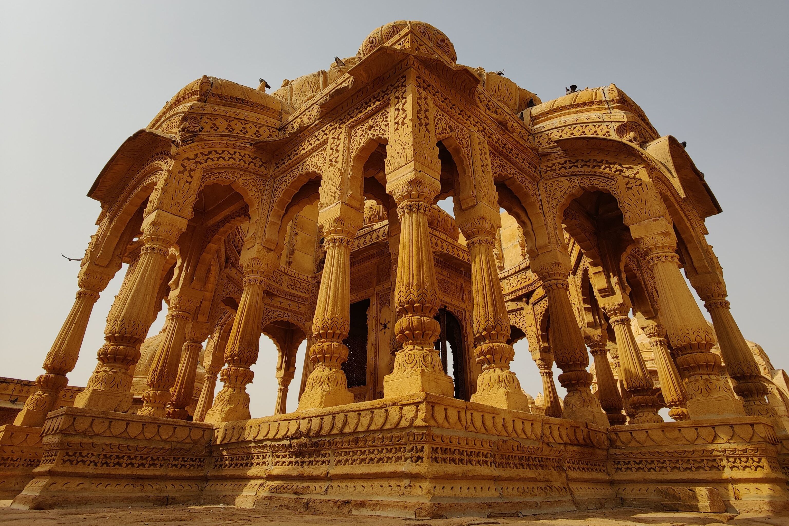 stunning sandstone cenotaphs of bada bagh in jaisalmer under a clear sky