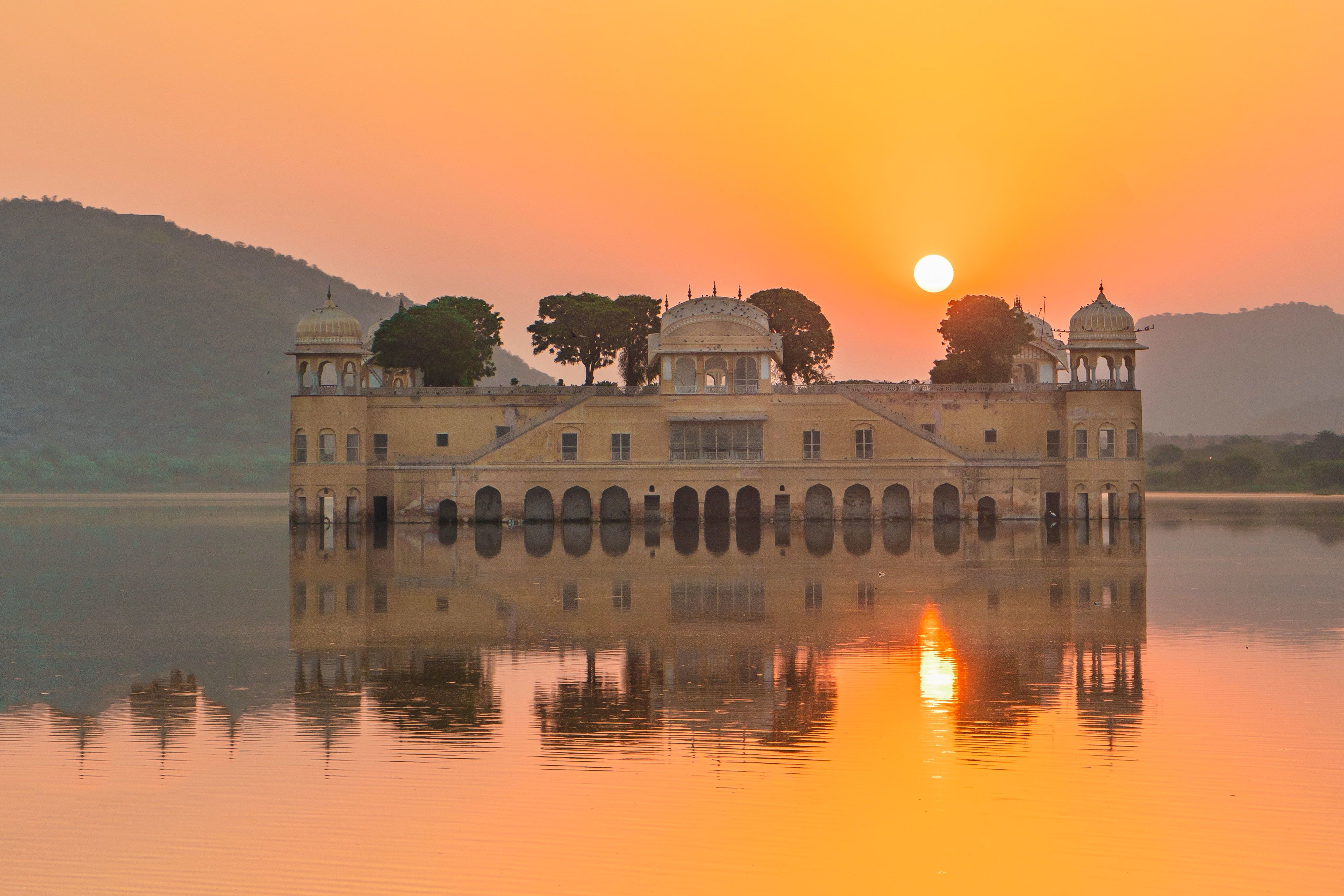 stunning view of the jal mahal palace reflecting on the man sagar lake during sunset in jaipur