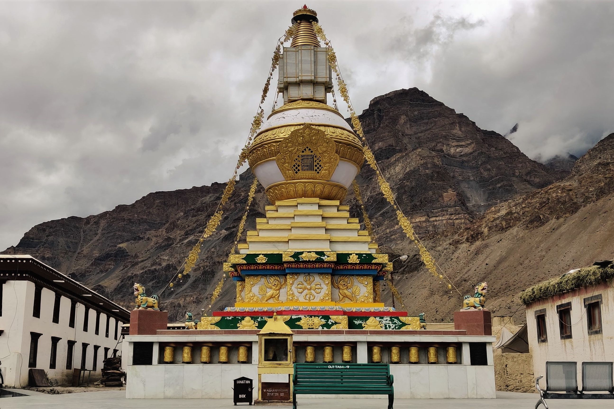 tabo monastery with brown mountains in the background on a cloudy day