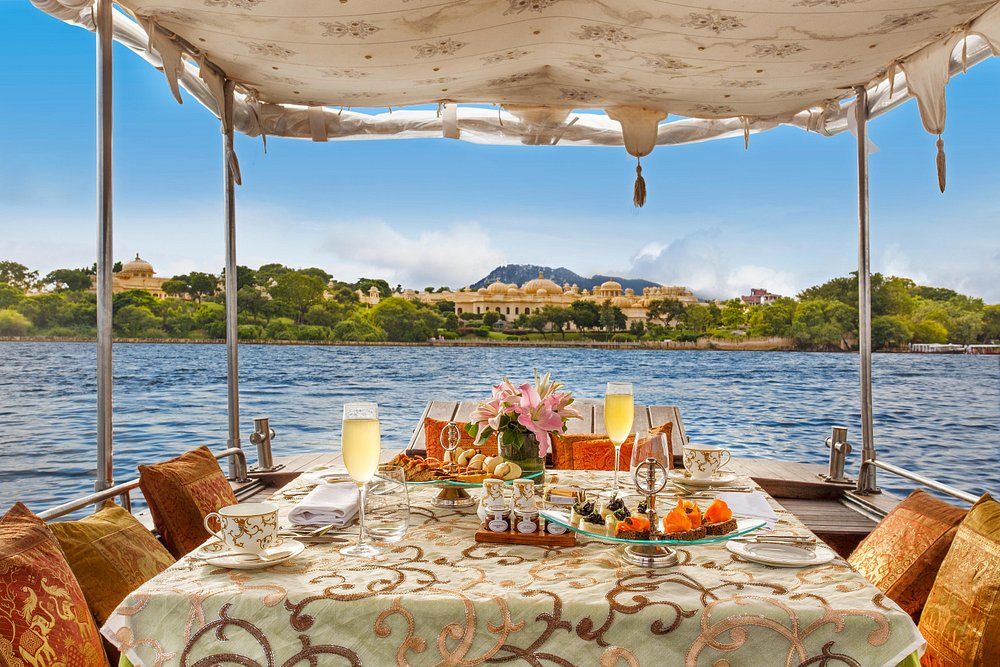 tea setup in a boat near oberoi udaivilas hotel in udaipur
