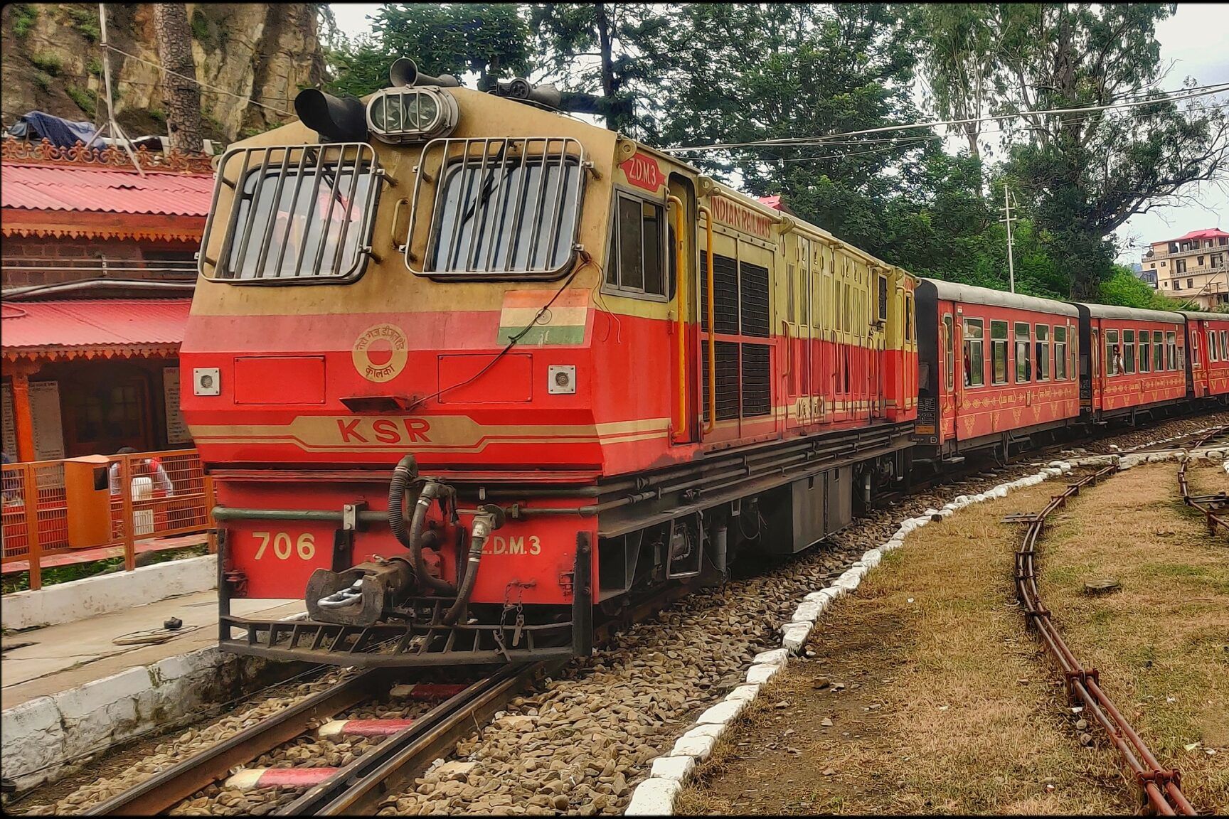 the kalka shimla toy train standing on a railway station