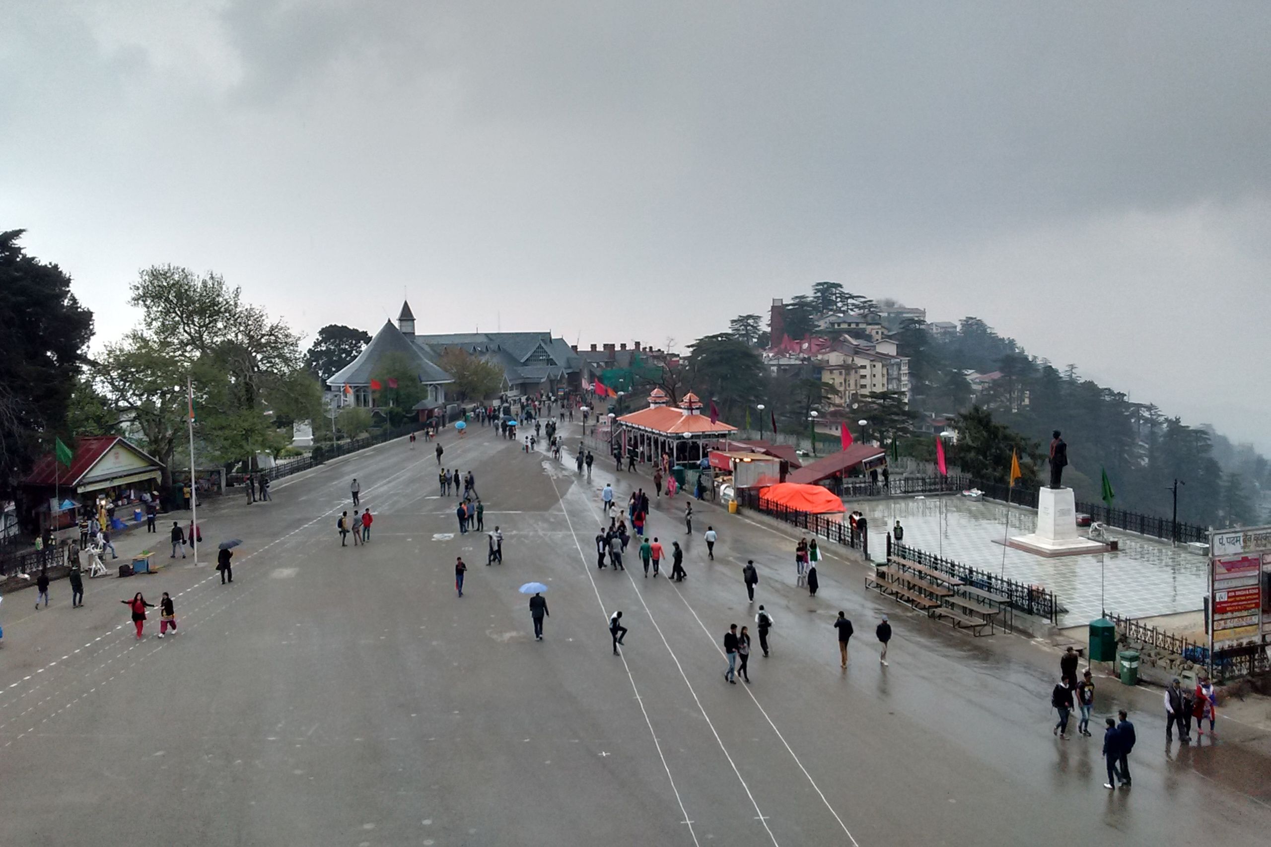 people walking on the ridge in shimla during a cloudy day