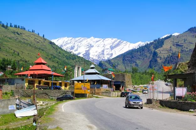 car on a narrow road from manali to atal tunnel