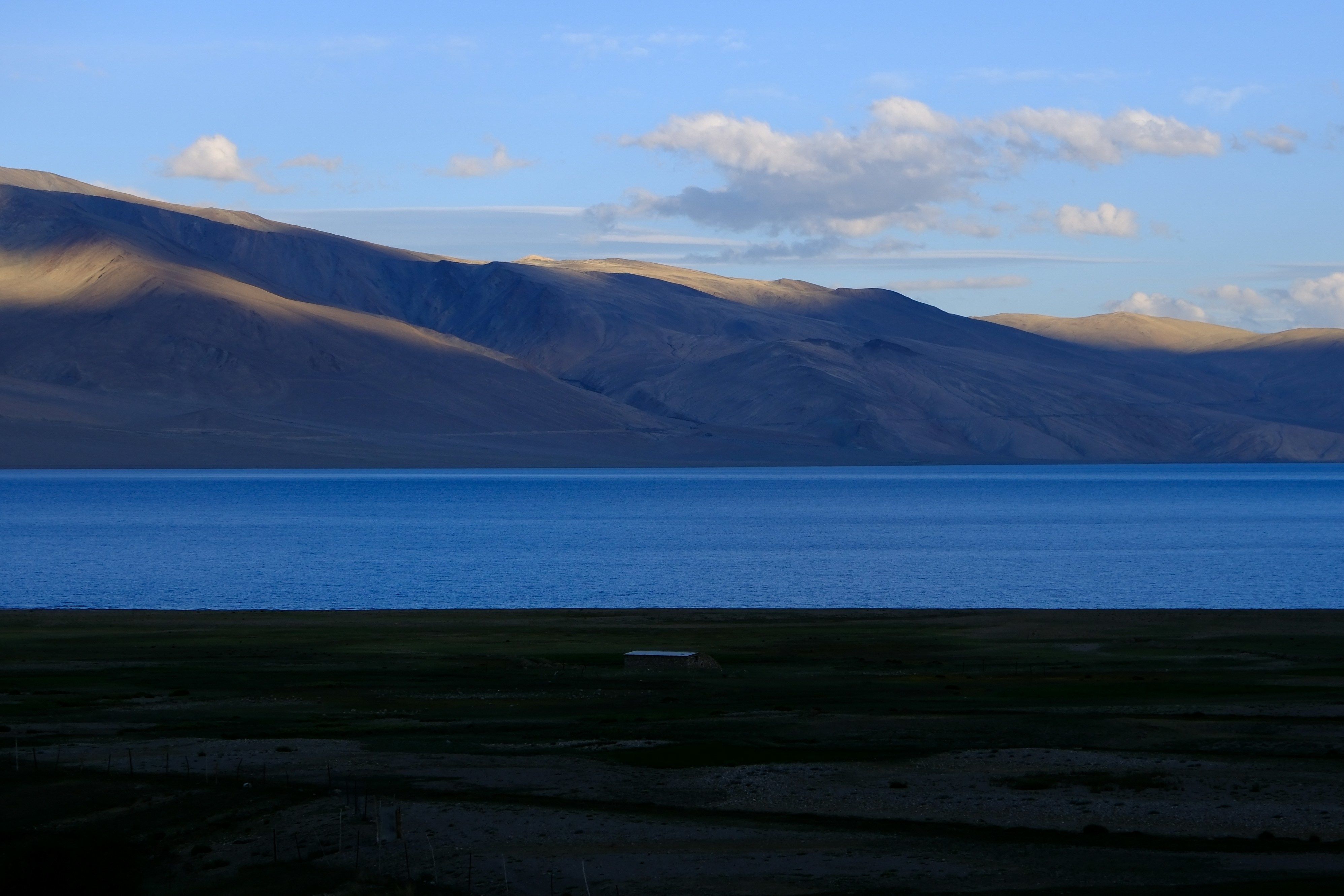 blue waters of tso moriri lake surrounded by mountains