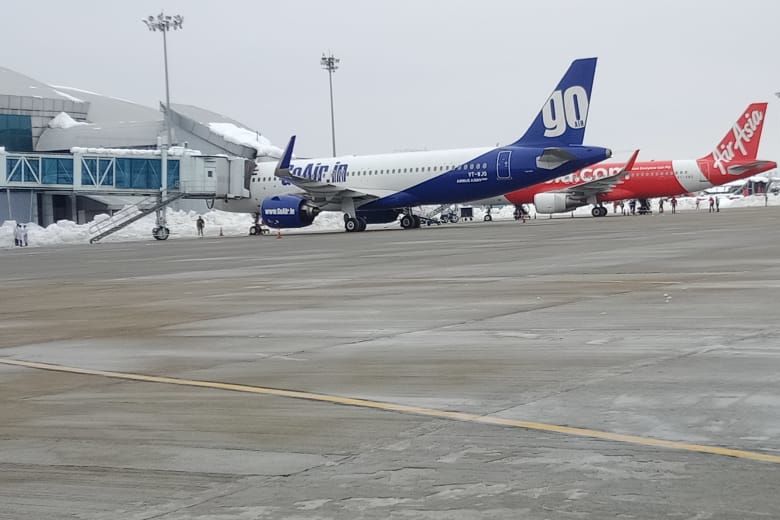 two aeroplanes standing at srinagar international airport