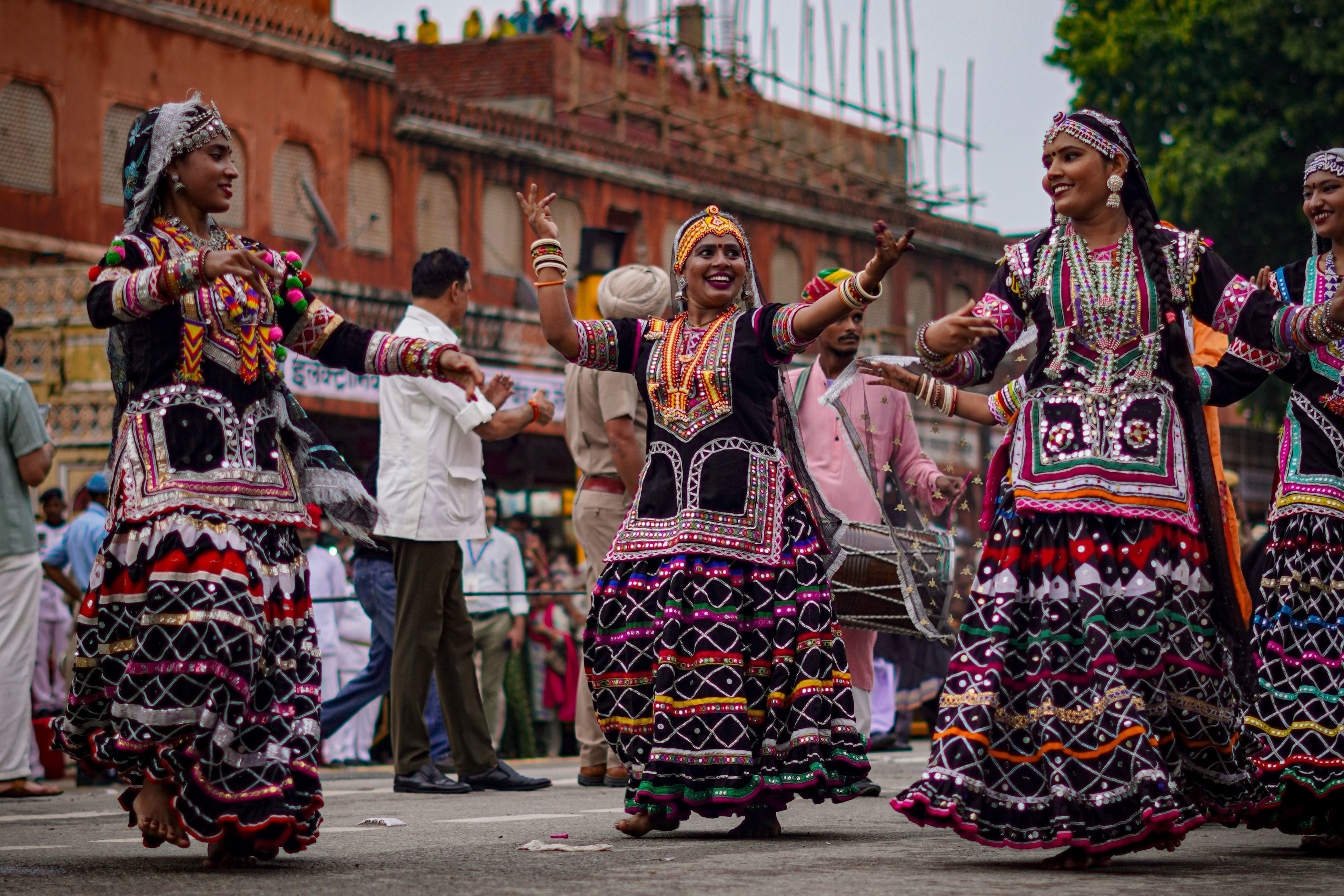 traditional dancers in colorful attire performing at an outdoor festival in rajasthan