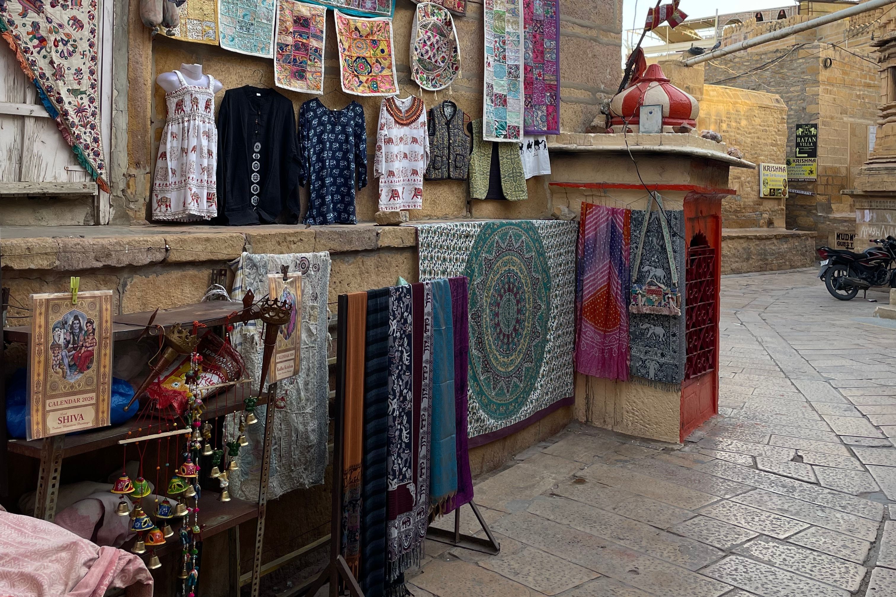vibrant textiles and garments displayed in jaisalmer market