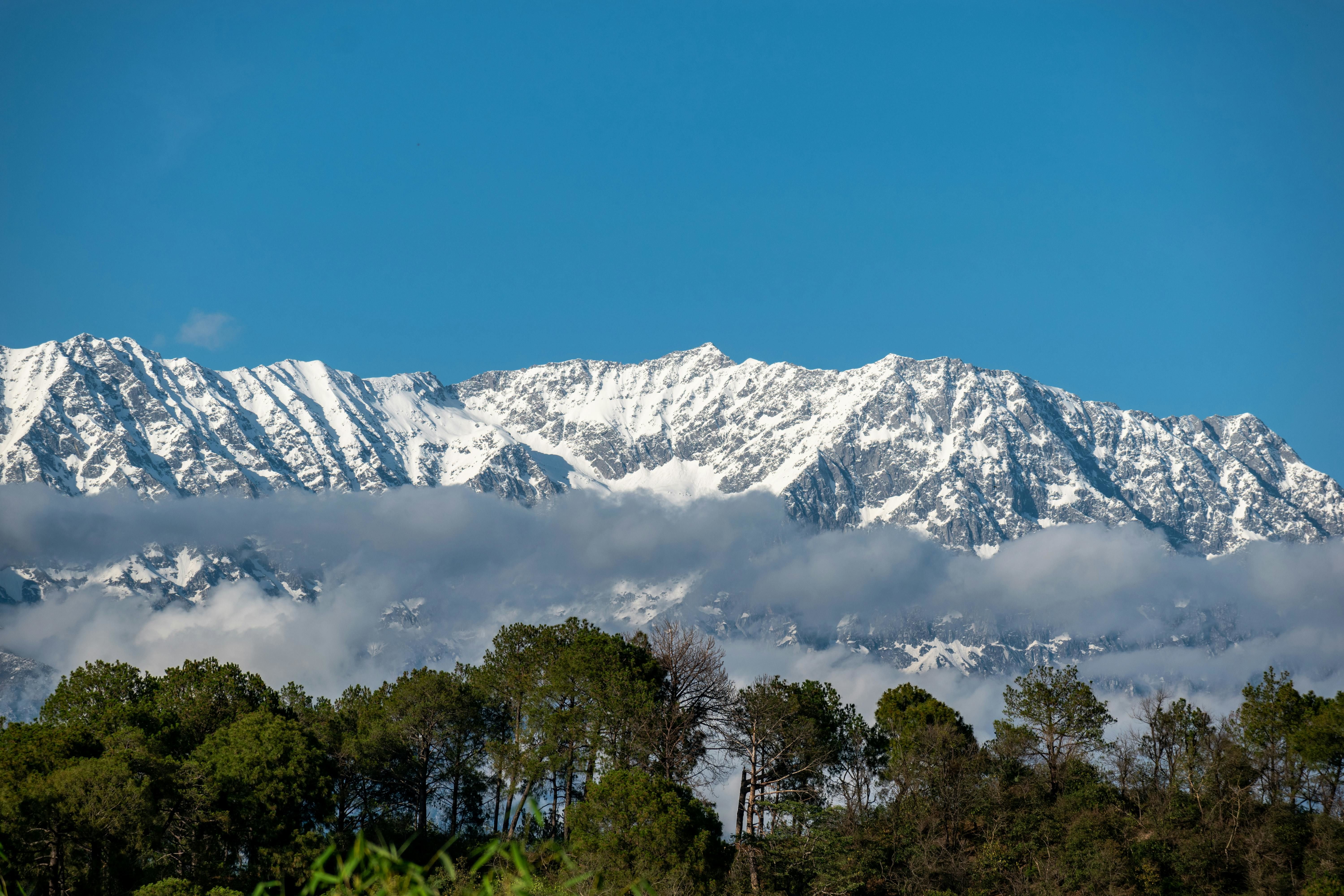 view of a snow covered mountain range in dharamshala