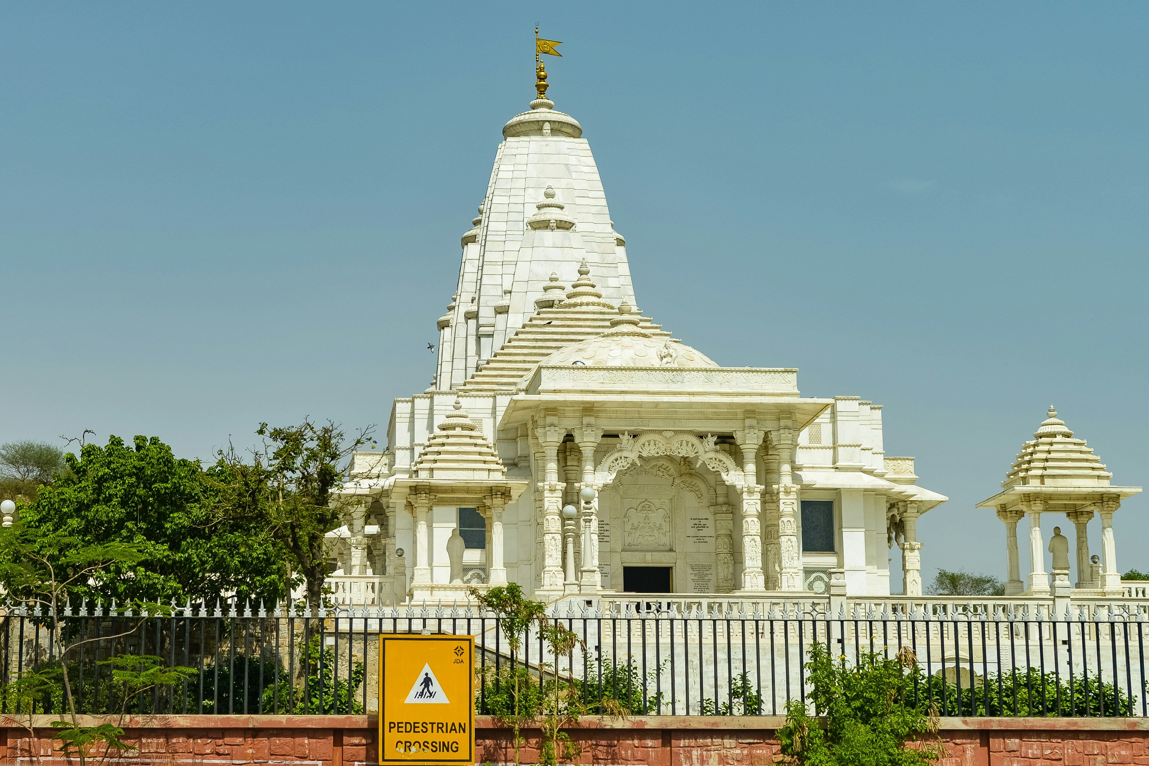 view of the birla temple with blue sky in the background during daytime