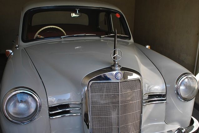 a vintage silver car on display at vintage car museum at updaipur