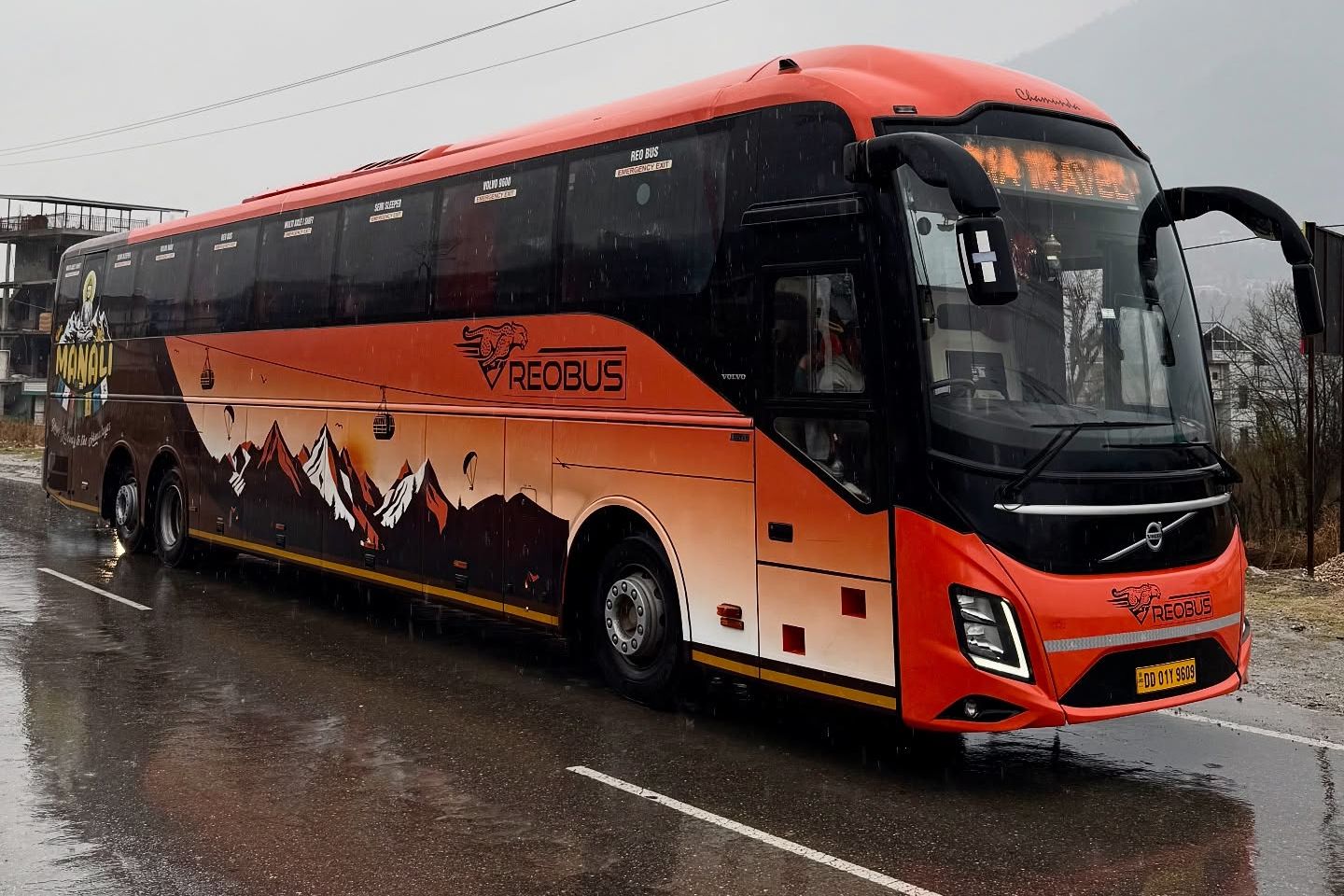 a volvo bus on road travelling between delhi and manali in rains