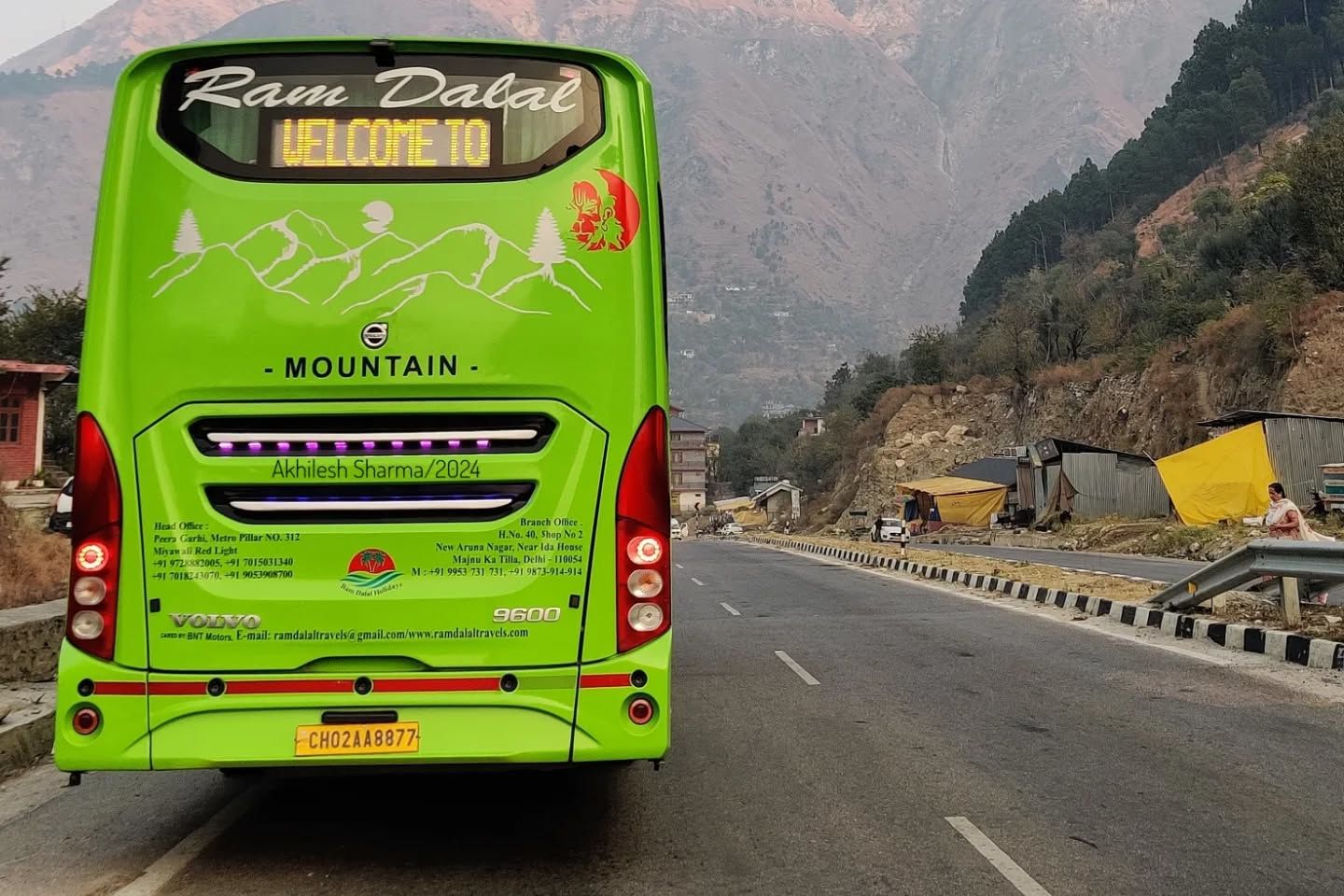 a volvo bus on road travelling between delhi and manali