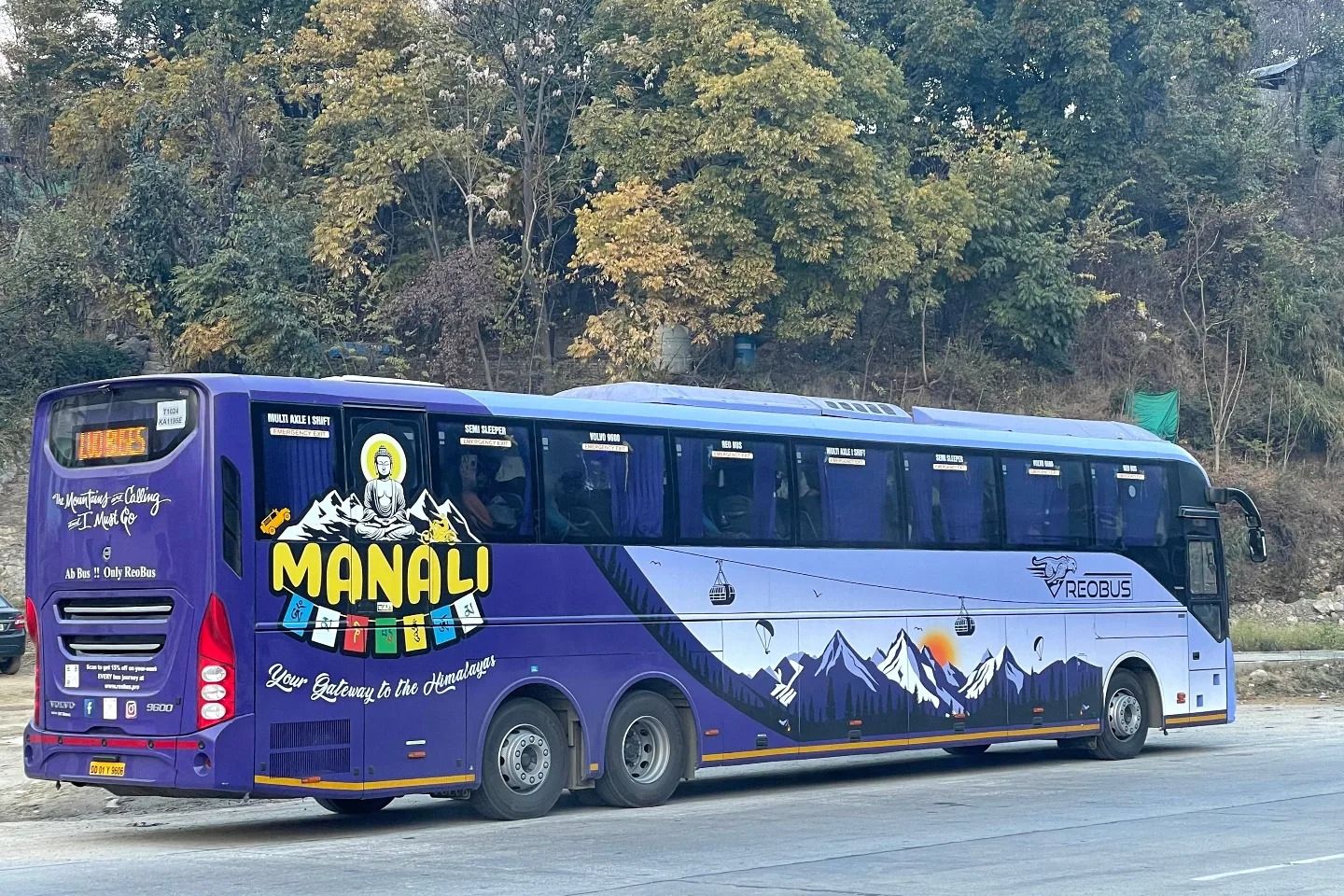 a volvo bus on road travelling between delhi and manali