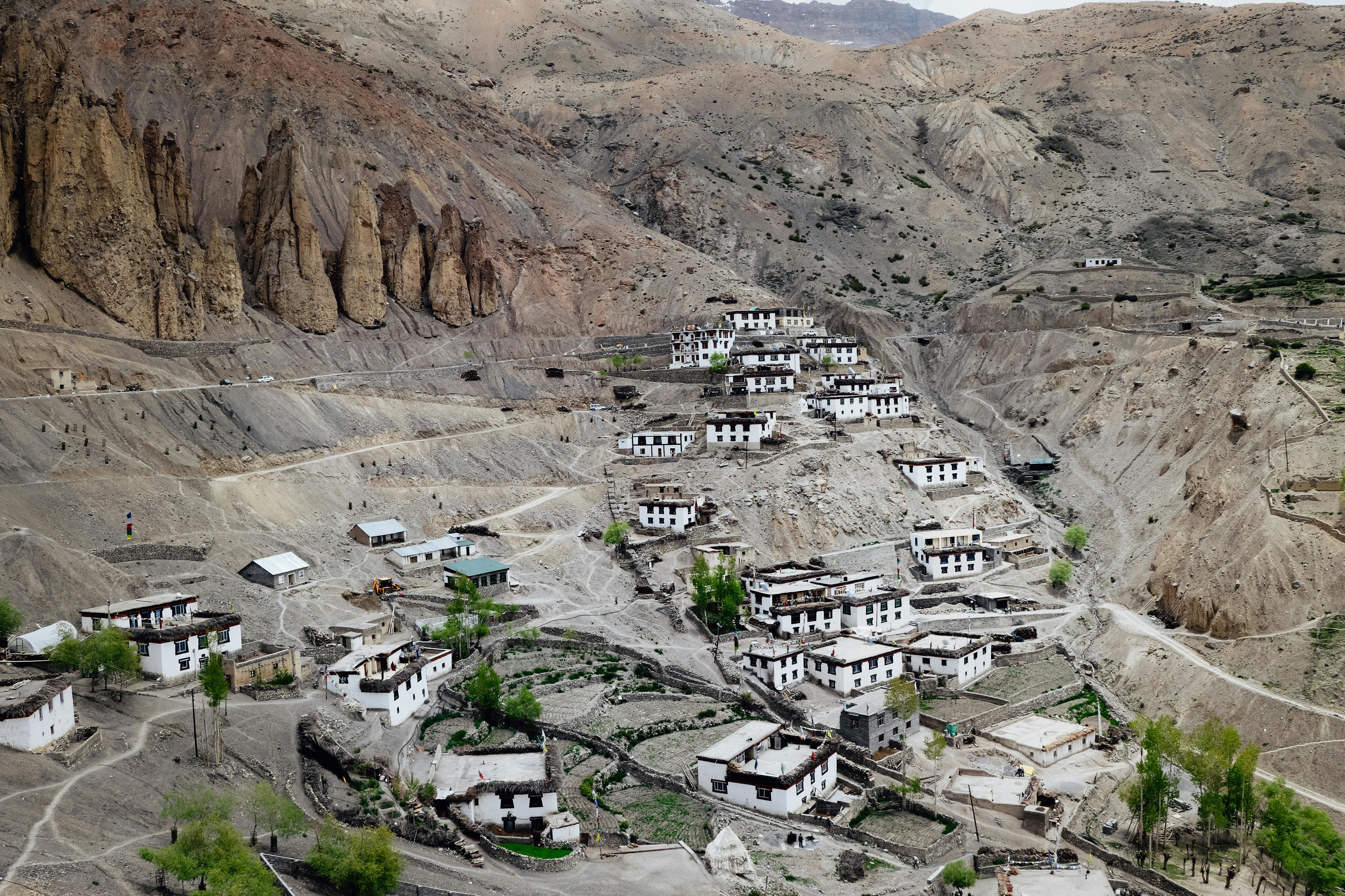 white and brown houses on a rocky mountain in dhankar
