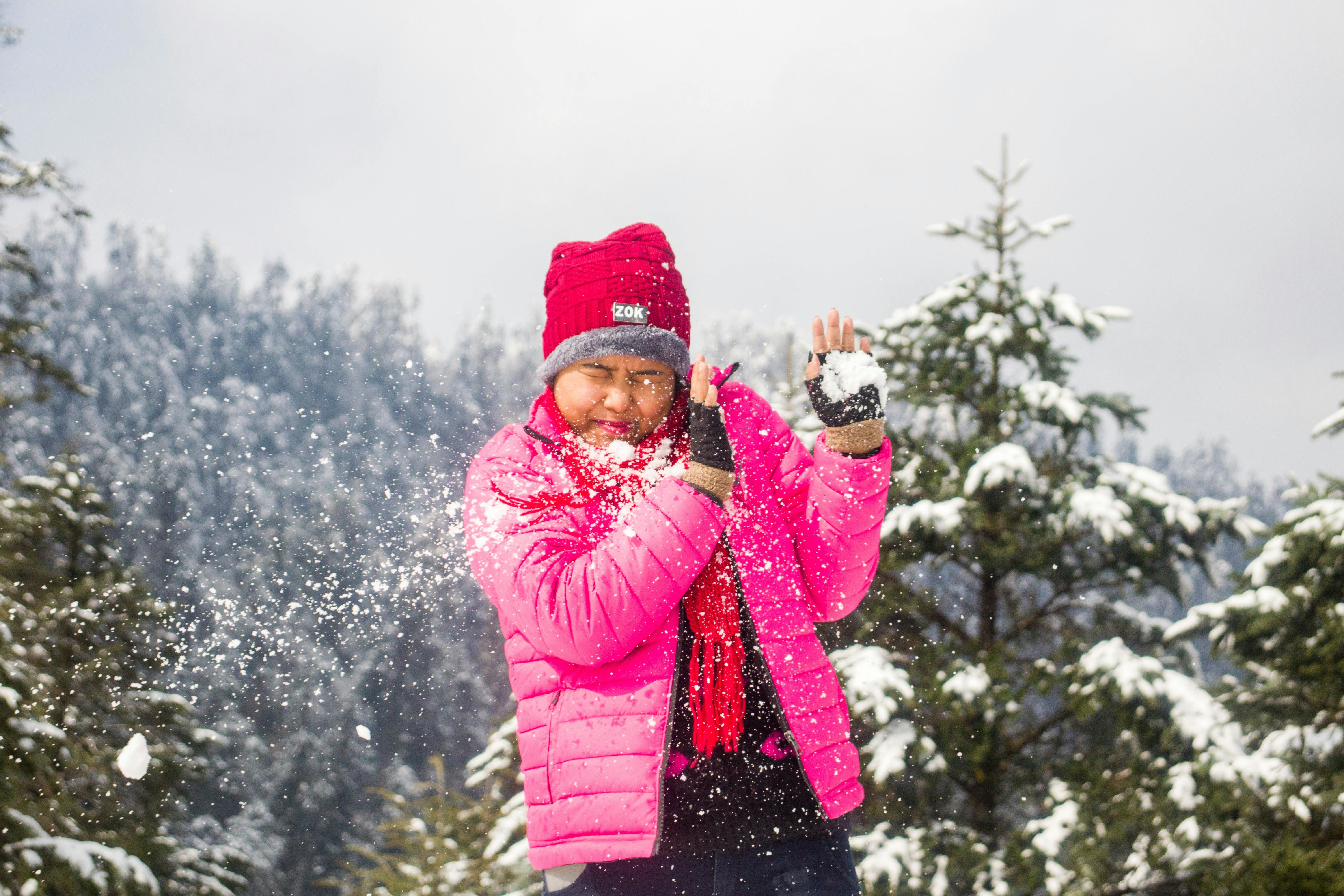 a tourist playing with snow in himachal pradesh