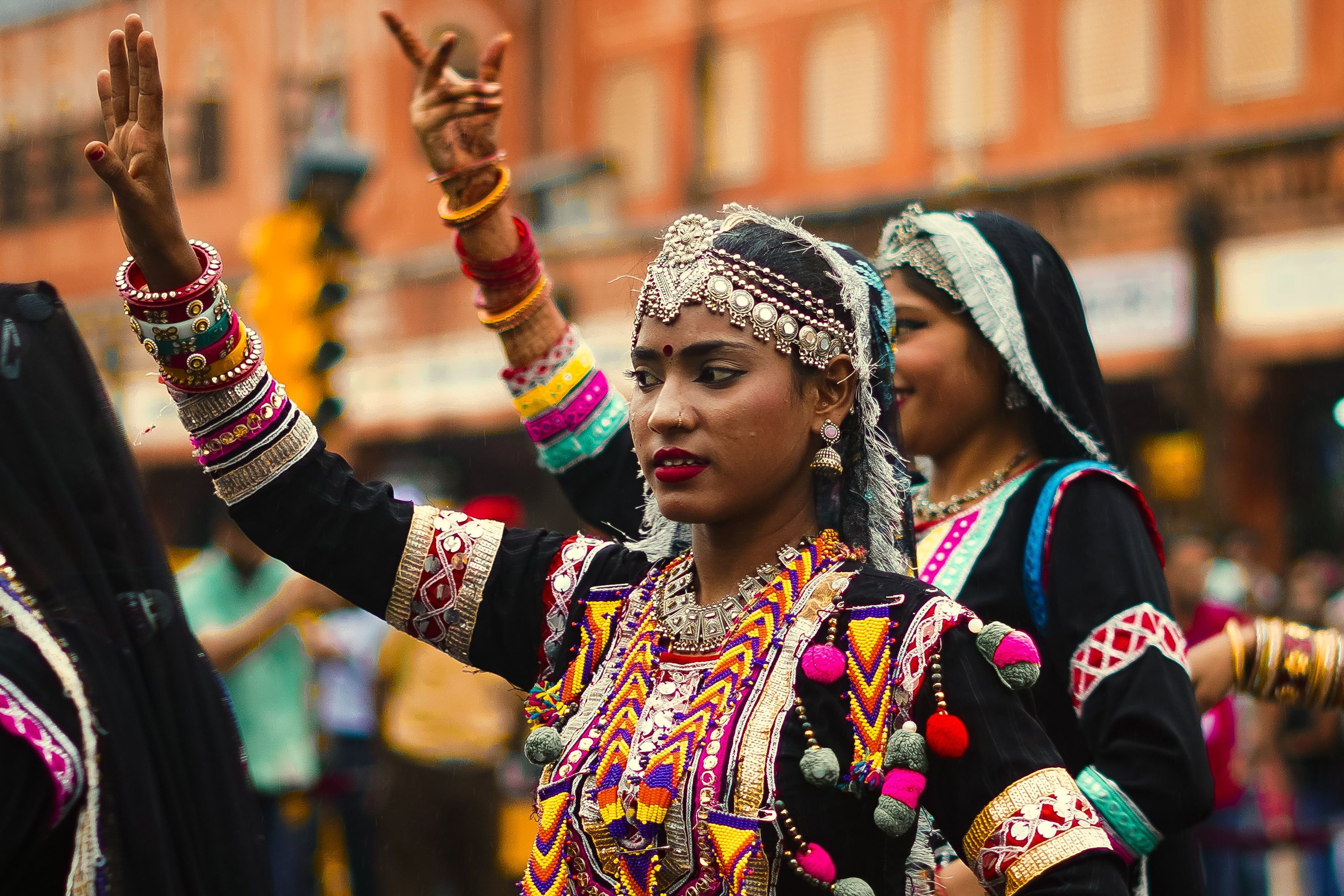traditional dancers in colorful attire performing at a festival in rajasthan