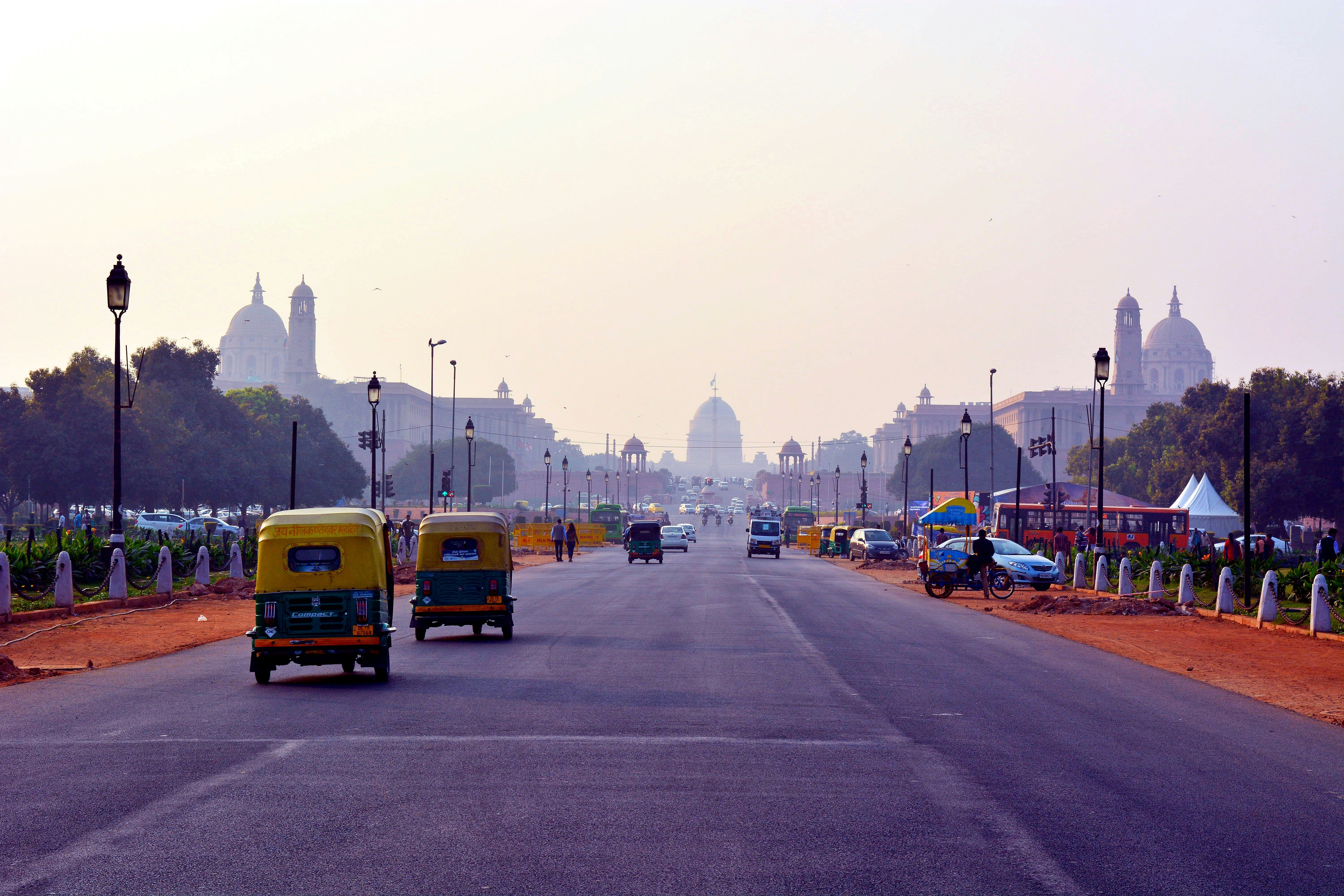 yellow auto rickshaw on road during daytime in new delhi